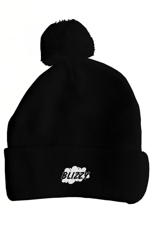 A black knit beanie with a pom-pom on top. The beanie features the word "BLIZZY" in a playful, stylized white font, accompanied by a cloud graphic. The design is casual and trendy, making it suitable for various outfits. The beanie has a snug fit, providing warmth and comfort.